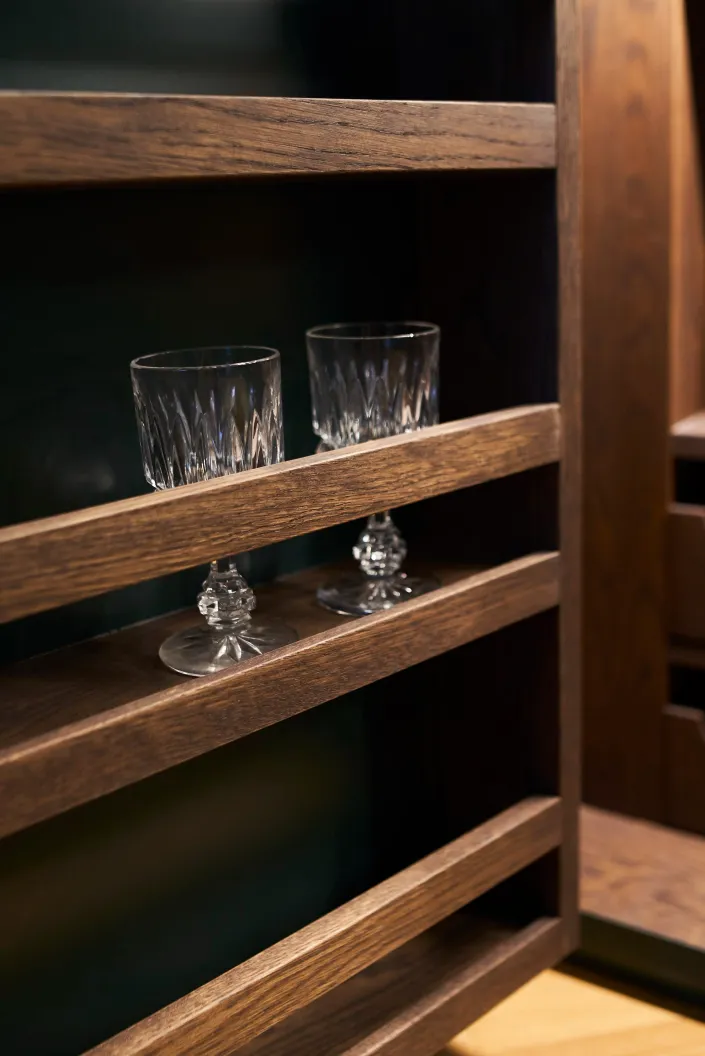 Dunkles Holzregal mit Kristallgläsern, Detail